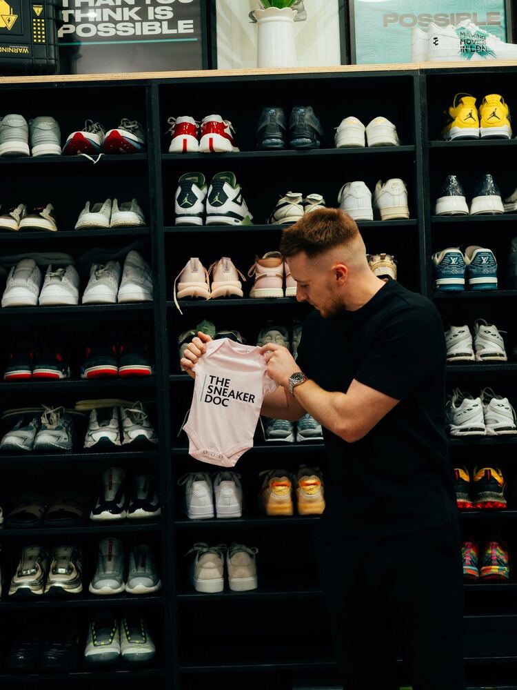 The Sneaker Doc team with trainers on the shelves in the Birmingham store